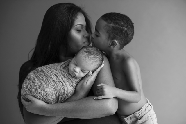 fotos newborn com irmão em e mão em ensaio de família recém-nascido